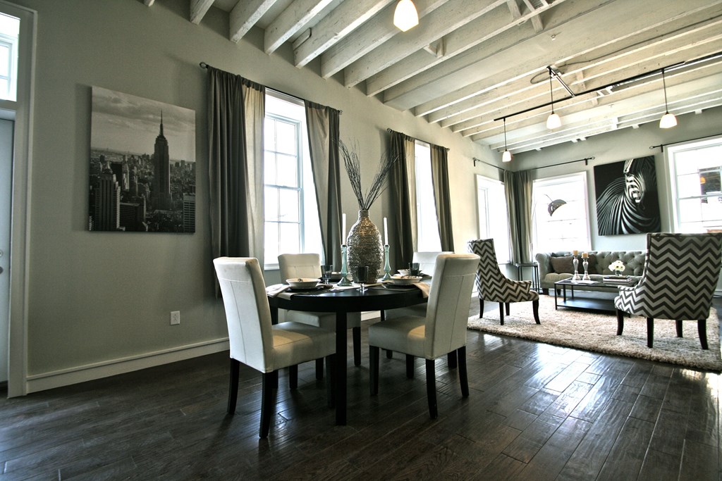 a dining room and living room with a table and chairs